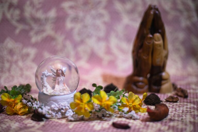 Aboriginal Dreamtime Healing without A snow globe and praying hands rest together.