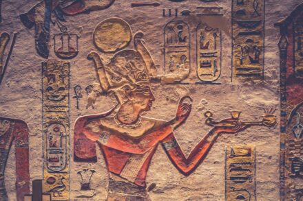 A painting of an egyptian god holding a cup