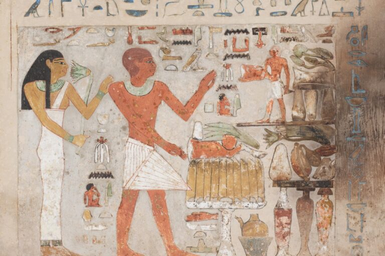 Ancient egyptian hieroglyphs and figures on a tomb wall.