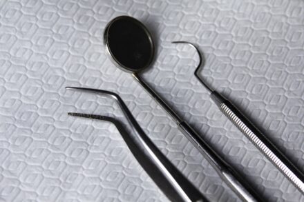 Acupuncture a pair of dental instruments sitting on top of a bed