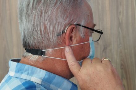 Acupuncture a man wearing a headset and a blue plaid shirt