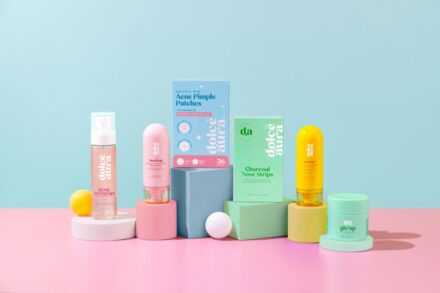 Assortment of skincare products arranged on pastel blocks.