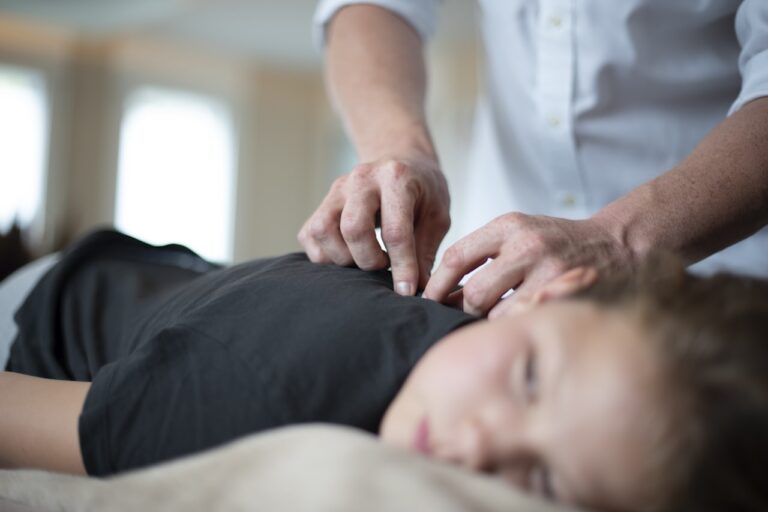 Ayurvedic Healing a woman getting a massage from a man in a white shirt