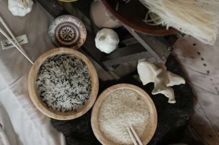 Two bowls of rice with chopsticks and without toppings