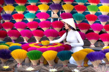 Chakra for Healing benefits a woman standing in front of a display of colorful fans