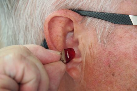 Ear Acupuncture Benefits 1 person wearing black framed eyeglasses