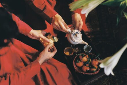 Herbal Medicine a woman in a red dress is pouring tea