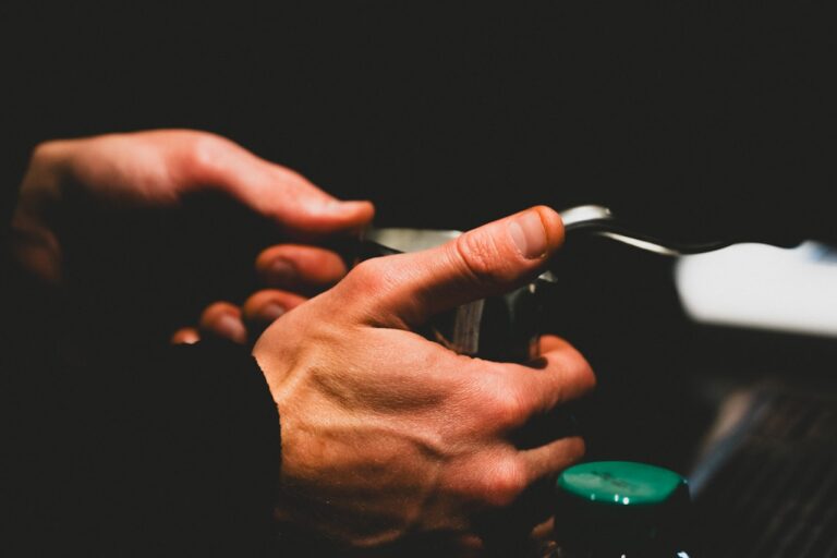 Herbal Medicine Hands carefully holding a small object with a green button.