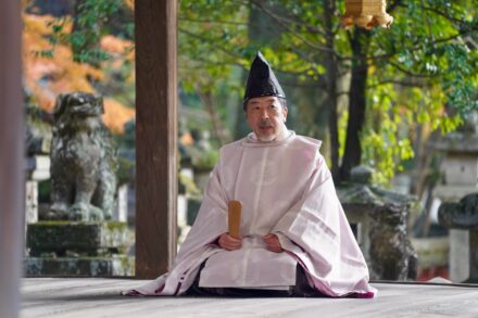 A priest sitting on the ground in a temple