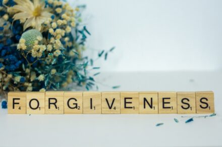 a scrabble type block spelling out the word forgiveness