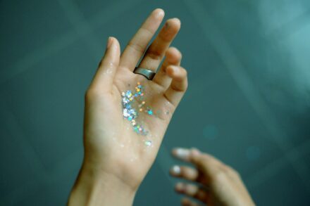 Crystal Healing person showing hands with glitters