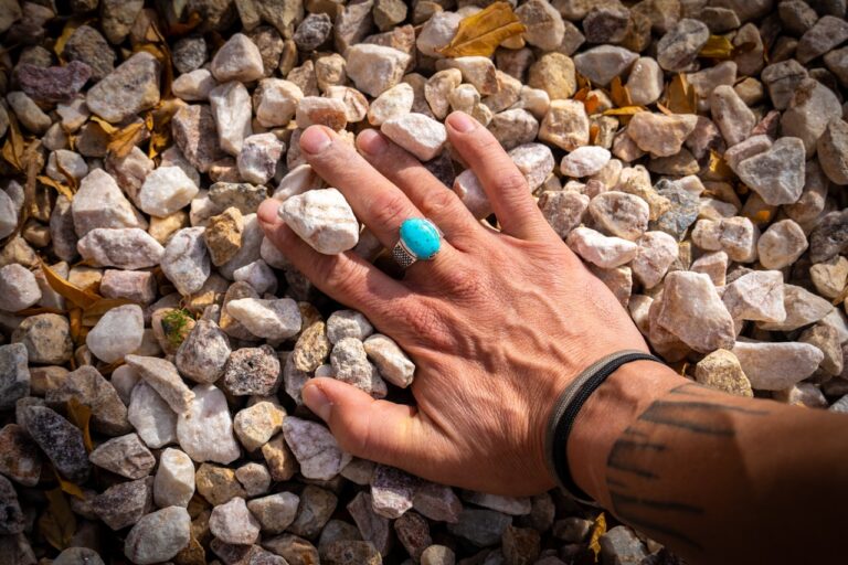 Crystal Healing A person's hand on a pile of rocks