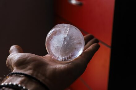 Crystal Healing person holding clear glass ball