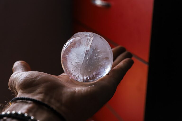 Crystal Healing person holding clear glass ball