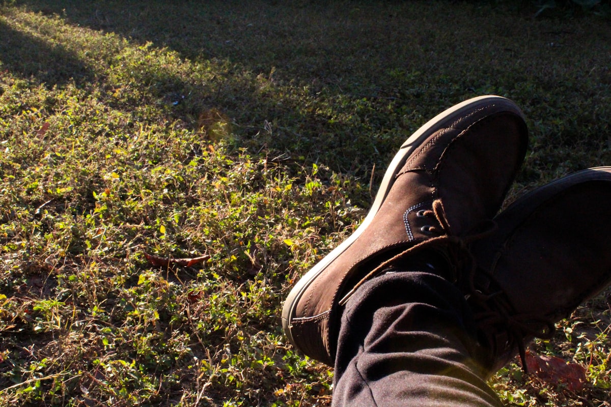 Grounding technique practiced by resting the feet on sunlit grass