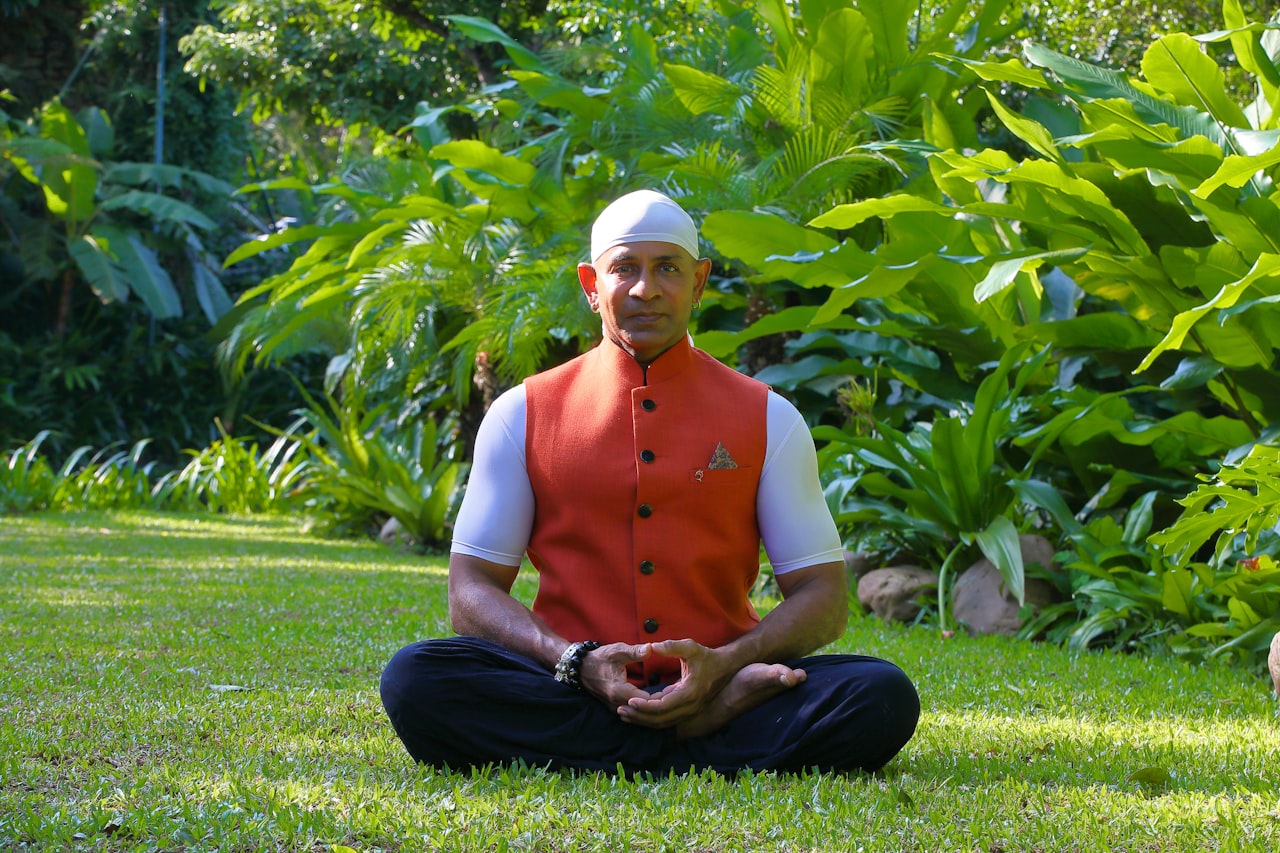 Man meditating cross-legged on grass during a guided meditation for healing