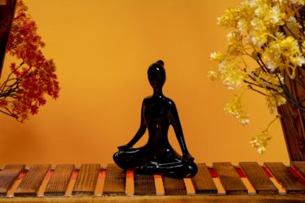 a statue of a person sitting in a yoga position