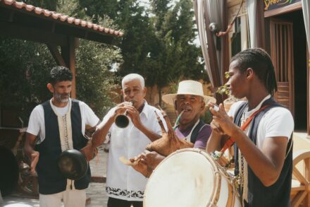 Group of men playing musical instruments outdoors