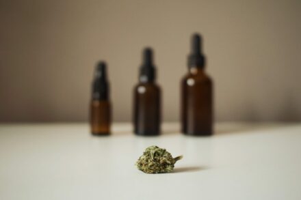 Herbal Medicine Mental Health: & 9 three bottles and a marijuana bud on a table