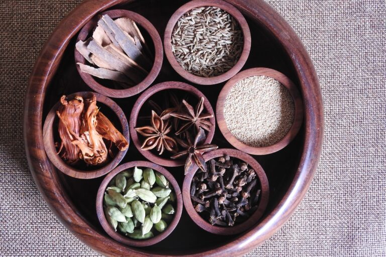 brown wooden round bowl with green and brown leaves
