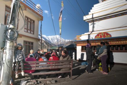 People ride in a truck with mountains in background