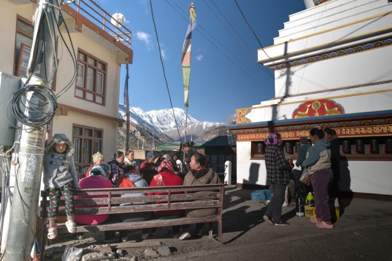 People ride in a truck with mountains in background