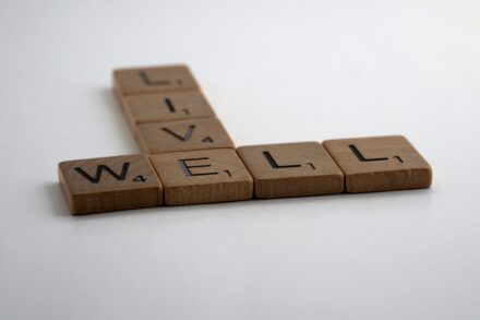 Rise Holistic 3 brown wooden blocks on white surface