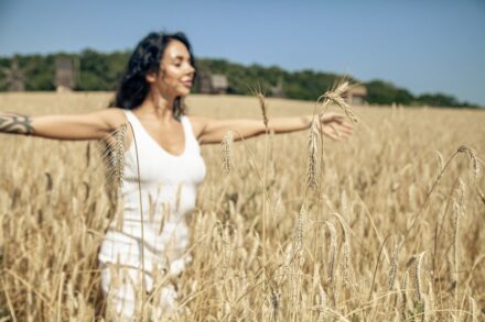 Holistic Healing A woman standing in a field of wheat
