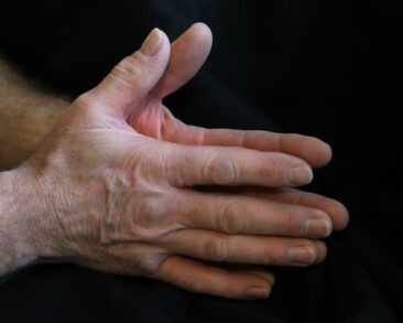 Practitioner demonstrating how energy healing works with hands above client