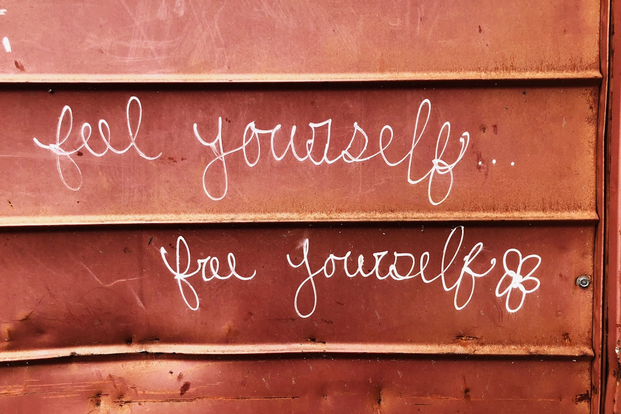 Wall painted with the handwritten words feel yourself, free yourself