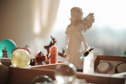 White angel figurine with various decorative objects