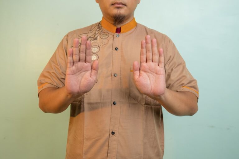 a man holding his hands up