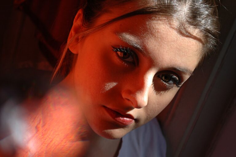 LED Nogier Frequency a woman with dark makeup is looking at the camera