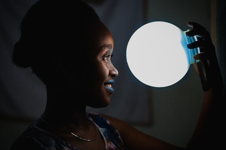 LED Nogier Frequency woman holding bulb