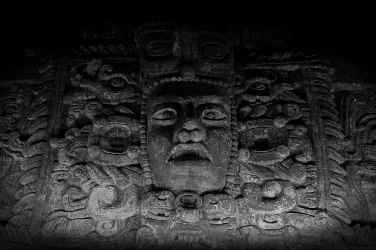 a black and white photo of a face on a wall