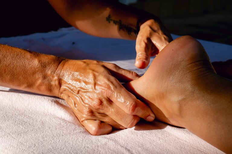 A woman getting a foot massage from a man