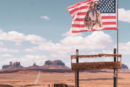 An american flag with a native american illustration.