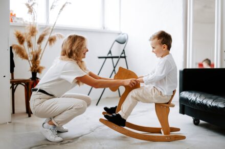 Physical Healing a woman and a child playing on a rocking chair