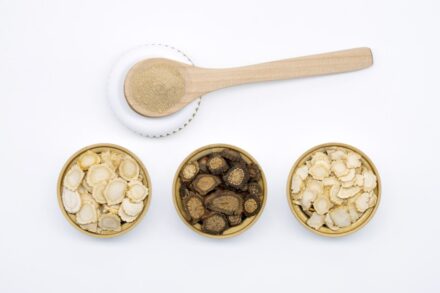 three bowls of cereal and a spoon on a white surface