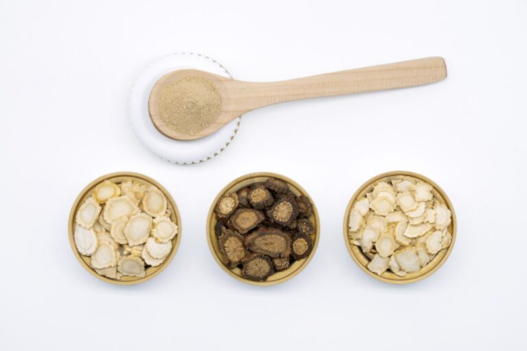 three bowls of cereal and a spoon on a white surface