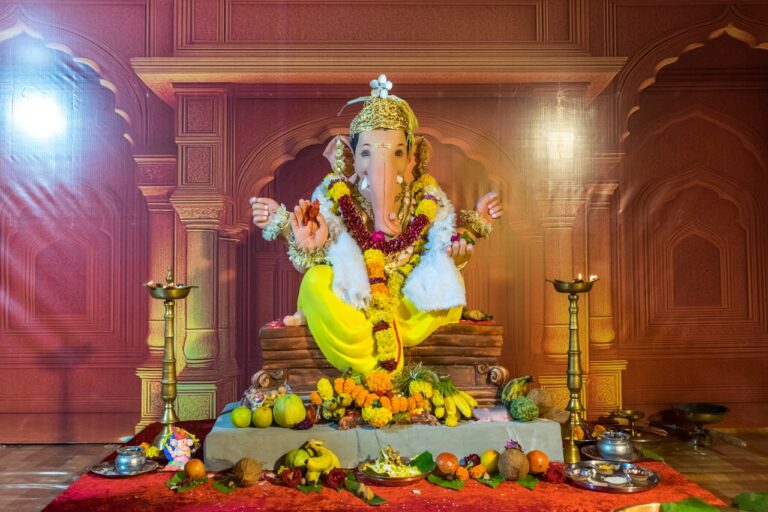 Lord ganesha idol decorated with flowers and fruits