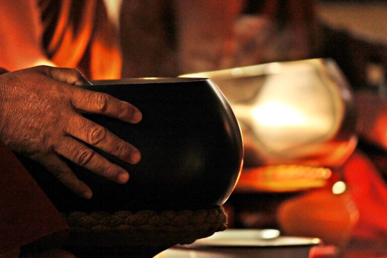 Monk holding a begging bowl with steam rising.