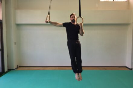 a man hanging upside down on a rope