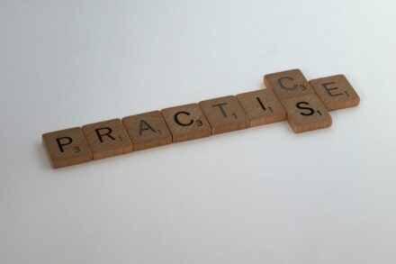 brown wooden cross on white surface