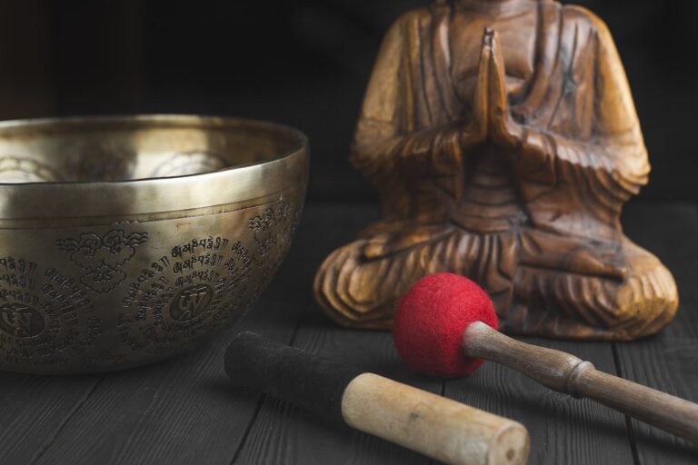 brass buddha figurine beside red and white stick