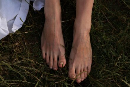 Quantum Foot Detox a woman's bare feet in the grass