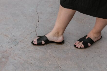 Quantum Foot Detox person wearing black sandals