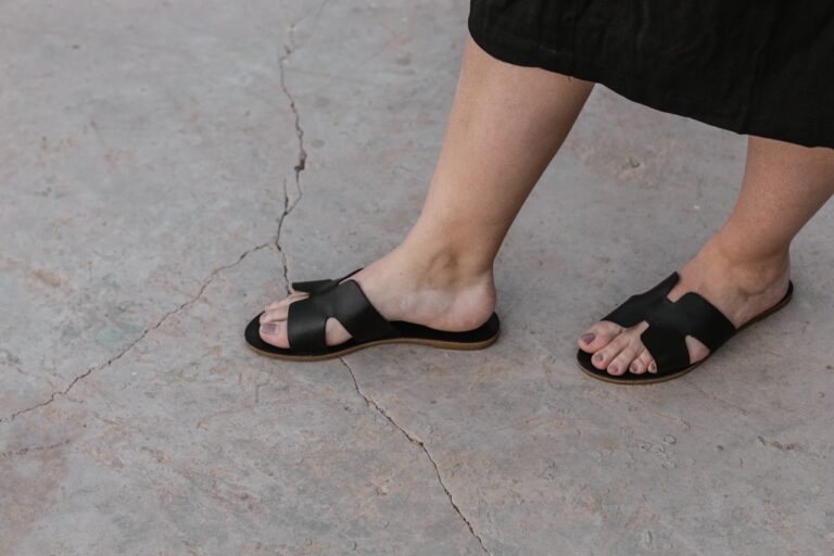 Quantum Foot Detox person wearing black sandals
