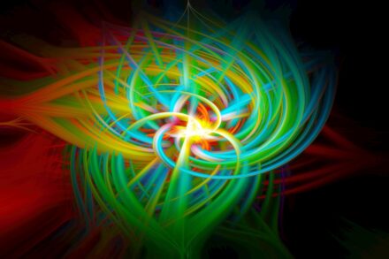 Abstract colorful light trails swirling in darkness