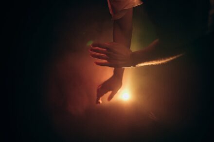 Quantum Healing & Techniques Two hands reaching out in dramatic lighting